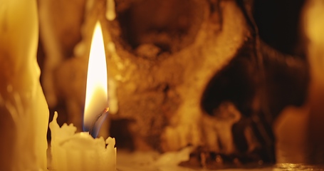 Image showing Candles and human skull in darkness closeup footage