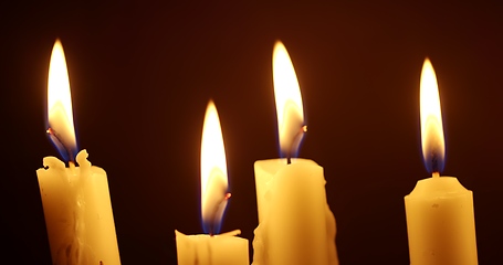 Image showing Candles glowing against dark background