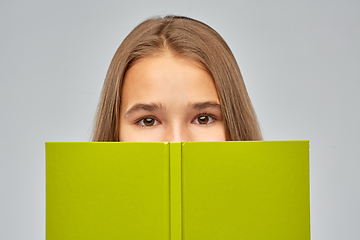 Image showing teenage student girl hiding over book