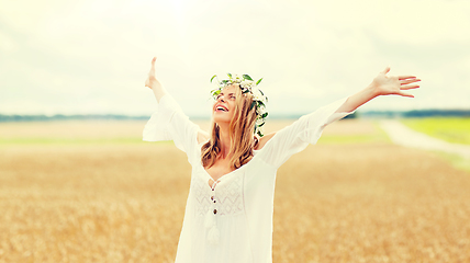 Image showing happy young woman in flower wreath on cereal field