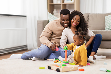 Image showing african family playing with baby daughter at home