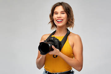 Image showing happy woman photographer with digital camera