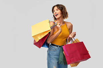 Image showing happy smiling young woman with shopping bags