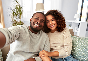 Image showing african american couple taking selfie at home