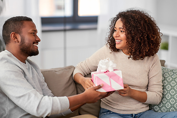 Image showing happy couple with gift at home