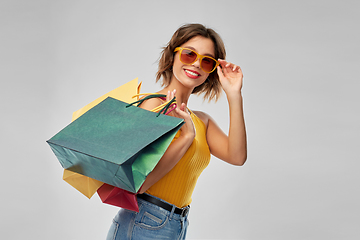 Image showing happy smiling young woman with shopping bags