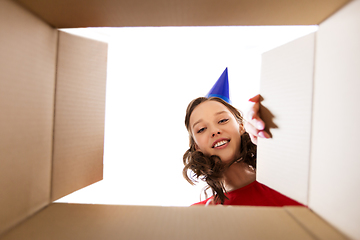 Image showing happy young woman looking into open birthday gift