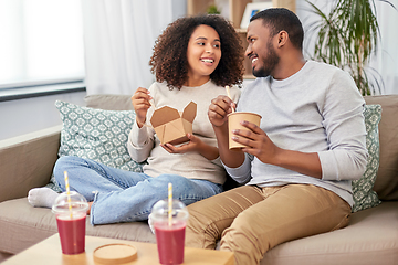 Image showing happy couple with takeaway food and drinks at home