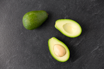 Image showing close up of ripe avocado on slate stone background