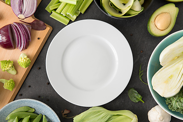 Image showing different green vegetables and white empty plate