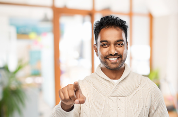 Image showing smiling indian man pointing finger to camera