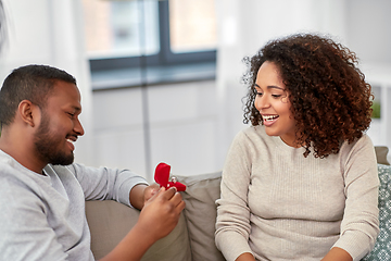 Image showing african american man giving woman engagement ring