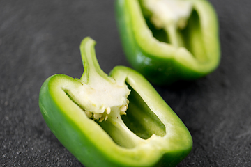 Image showing cut green pepper on slate stone background