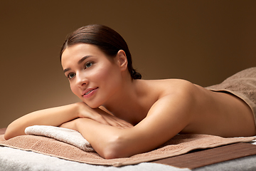 Image showing young woman lying at spa salon or massage parlor