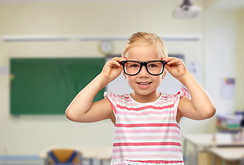 Image showing smiling cute little girl in black glasses