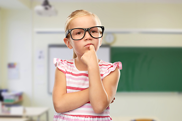 Image showing cute little girl in black glasses thinking