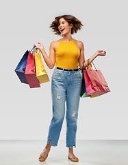 Image showing happy smiling young woman with shopping bags