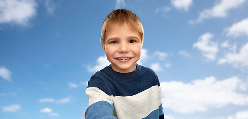 Image showing happy little boy in striped pullover taking selfie