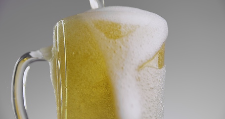 Image showing Beer overflowing from large mug 120fps slow motion footage