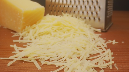 Image showing Parmesan cheese on the table as ingridiend in camera motion