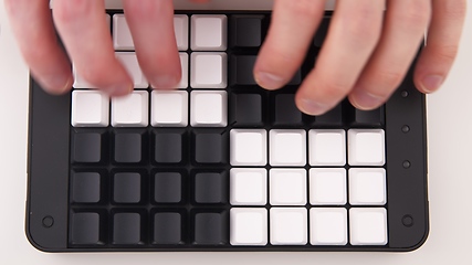 Image showing Hands typing fast on Unlabeled keyboard