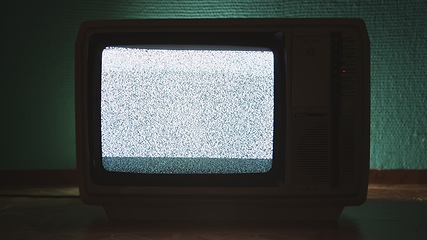 Image showing Old TV agains green background