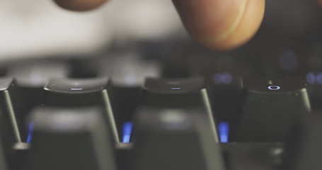 Image showing Close-up of typing male hands on illuminated keyboard