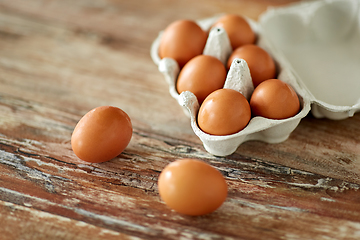 Image showing close up of eggs in cardboard box on wooden table