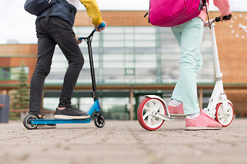 Image showing school children with backpacks and scooters