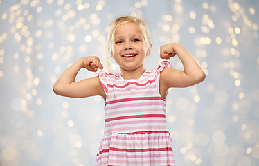 Image showing smiling little girl showing her power