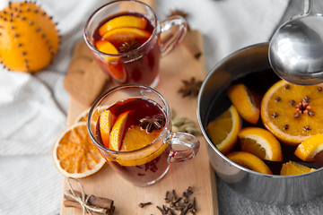 Image showing pot with hot mulled wine, orange slices and spices