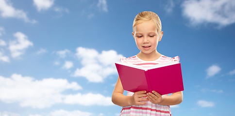 Image showing little girl reading book over sky background