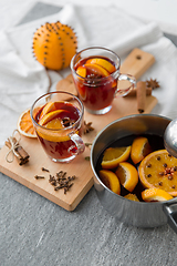 Image showing pot with hot mulled wine, orange slices and spices