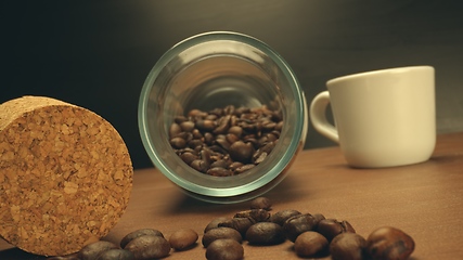 Image showing Roasted coffee beans on table in camera motion