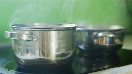 Image showing Steam or vapor clouds rising from boiling oil