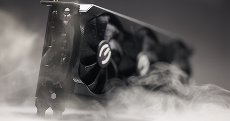 Image showing Graphics card with smoke rising and dark background