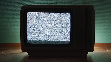 Image showing Old TV agains green background