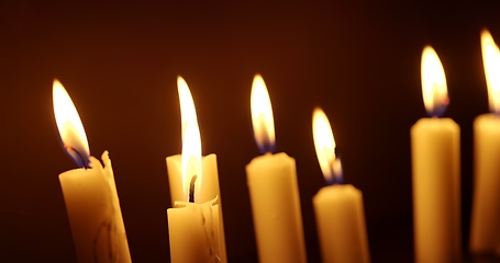 Image showing Candles glowing against dark background