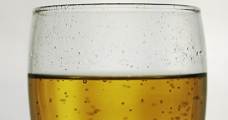 Image showing Glass of beer on the table slow motion footage