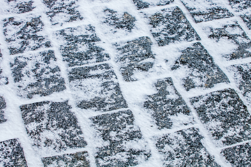 Image showing Cobblestone pavement covered with snow and ice