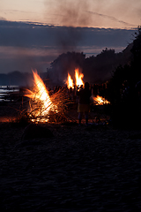 Image showing Unrecognisable people celebrating summer solstice with large bonfires on beach