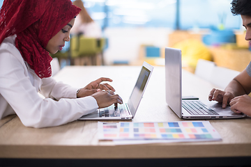 Image showing black muslim business woman ,working on laptop computer