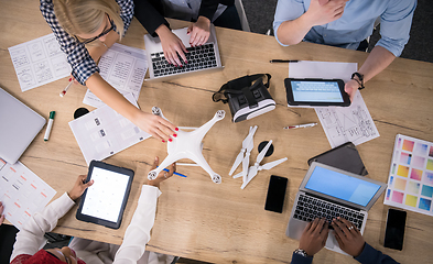 Image showing top view of multiethnic business team learning about drone techn