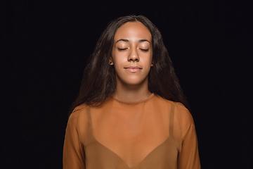 Image showing Close up portrait of young woman isolated on black studio background