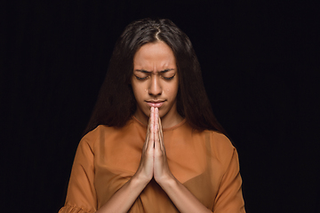 Image showing Close up portrait of young woman isolated on black studio background