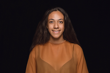 Image showing Close up portrait of young woman isolated on black studio background