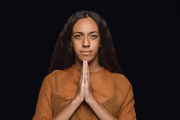 Image showing Close up portrait of young woman isolated on black studio background