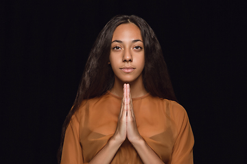 Image showing Close up portrait of young woman isolated on black studio background