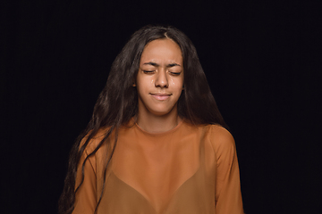 Image showing Close up portrait of young woman isolated on black studio background