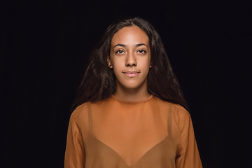 Image showing Close up portrait of young woman isolated on black studio background